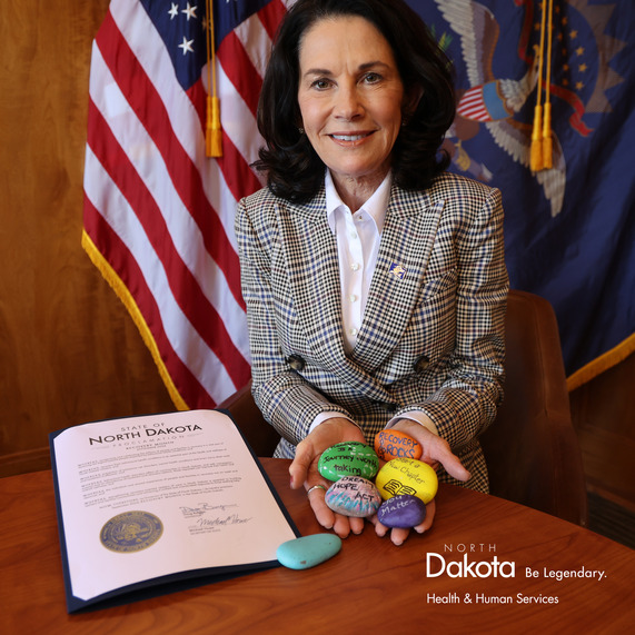 Lt. Gov. Tammy Miller displays inspirational painted rocks near Gov. Doug Burgum's Recovery Month proclamation