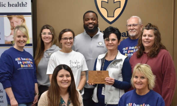 CCHD Staff and BOH members posing together holding the NDPHA Public Health Team of the Year award plaque